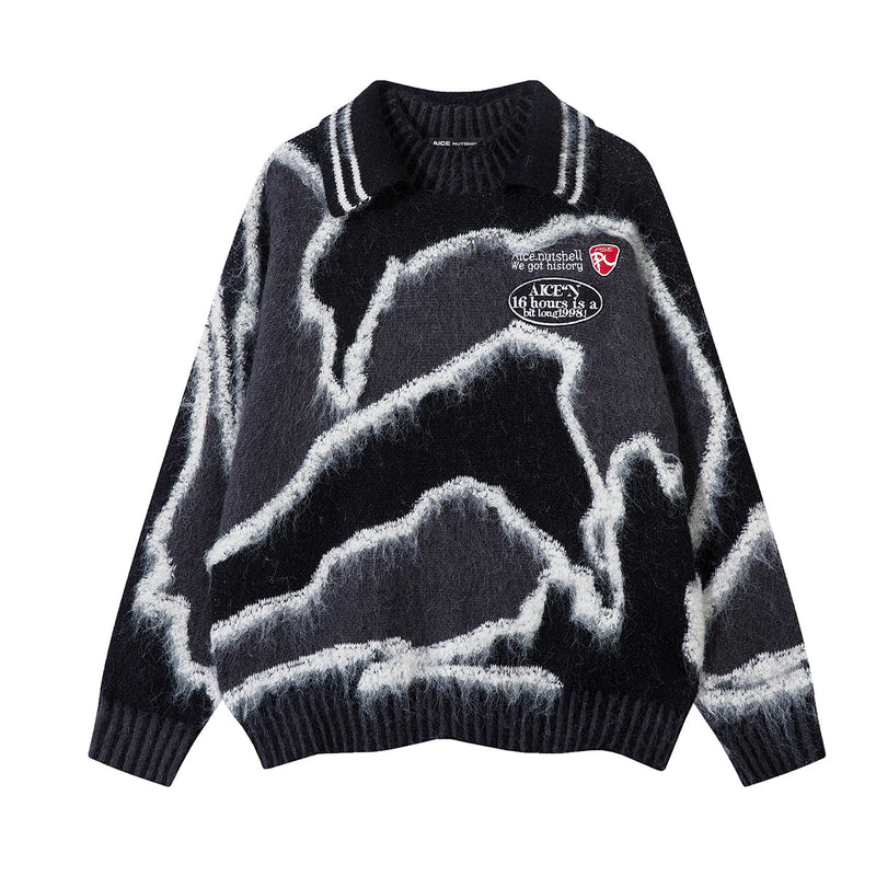 Oversized abstract camo jacquard polo collar knit sweater in black with white contrast pattern and embroidered chest patches