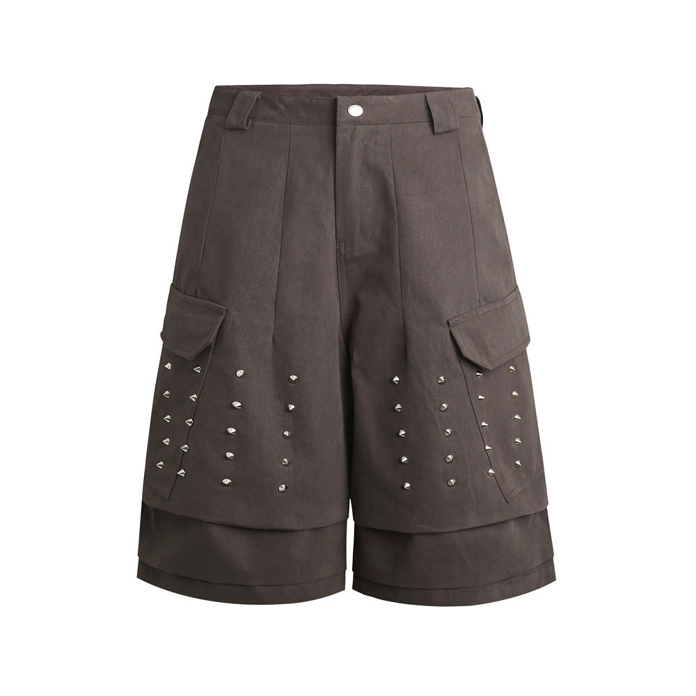Men's wide-leg cargo shorts with silver cone stud embellishments and layered hem in charcoal grey