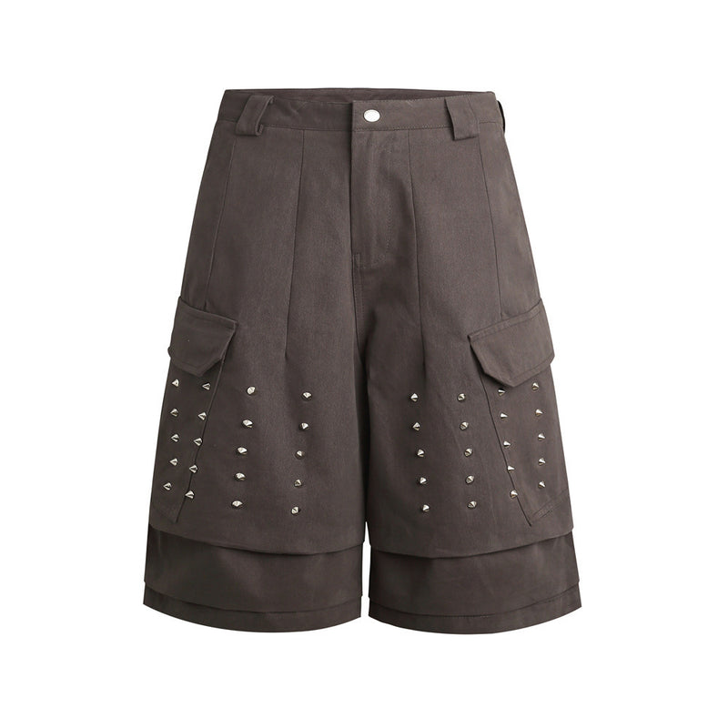 Men's wide-leg cargo shorts with silver cone stud embellishments and layered hem in charcoal grey
