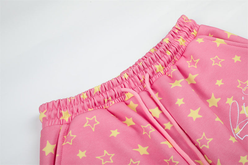 Close-up of pink star print sweatpants waistband with elastic ruching and drawstring