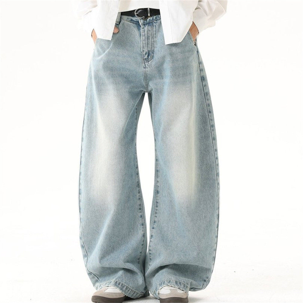 Men's vintage washed light blue wide-leg baggy jeans with curved raw hem and oversized silhouette