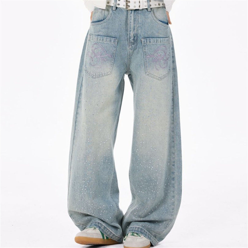Men's light blue baggy wide-leg denim jeans with rhinestone scatter detailing and dragon embroidery on front patch pockets