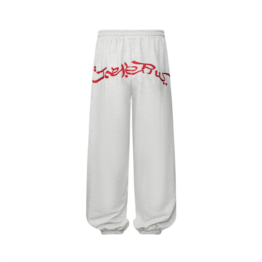 Pantalon de survêtement homme à jambes larges avec écusson brodé et imprimé graphique en écriture