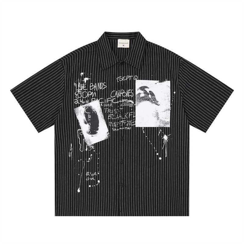 Men's oversized black pinstripe short-sleeve button-up shirt with abstract graffiti and ink-splash graphic print on the front