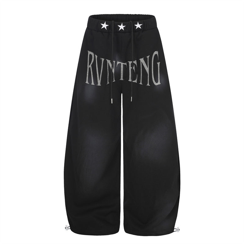 Pantalones de chándal holgados de pernera ancha con lavado efecto spray y gráfico de letras