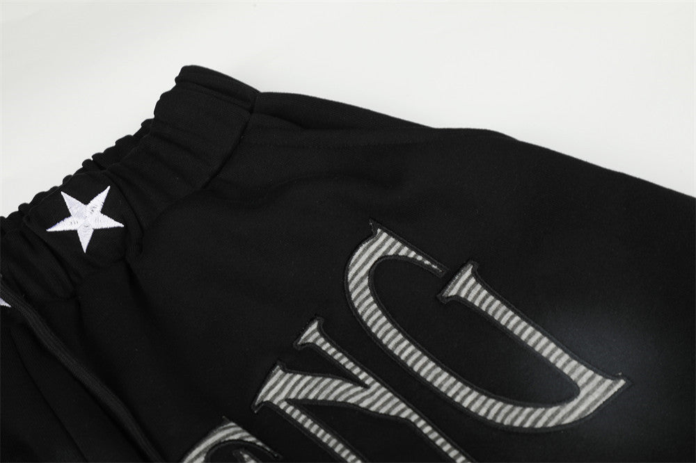 Pantalones de chándal holgados de pernera ancha con lavado efecto spray y gráfico de letras