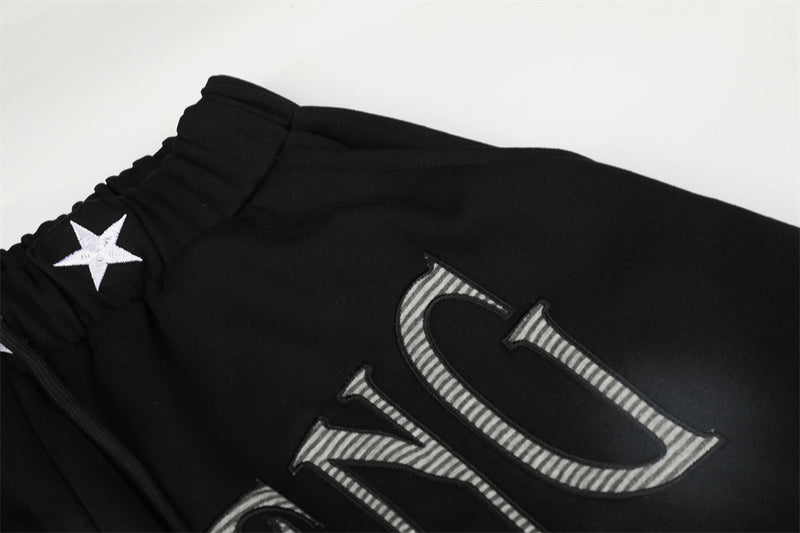 Pantalones de chándal holgados de pernera ancha con lavado efecto spray y gráfico de letras