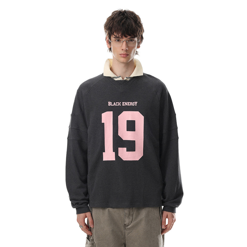 Oversized charcoal grey long sleeve sweatshirt with pink No.19 number print and Black Energy text on chest, V-neckline and ra