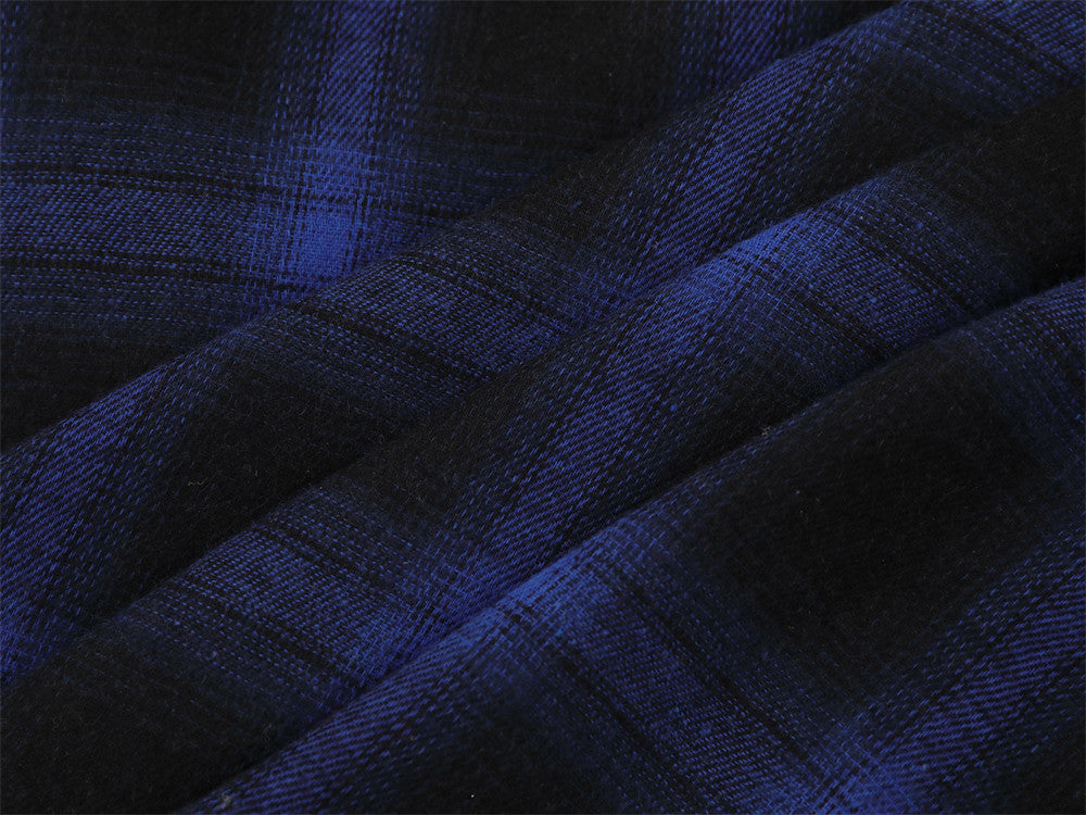 Close-up of blue and black plaid fabric folds and texture