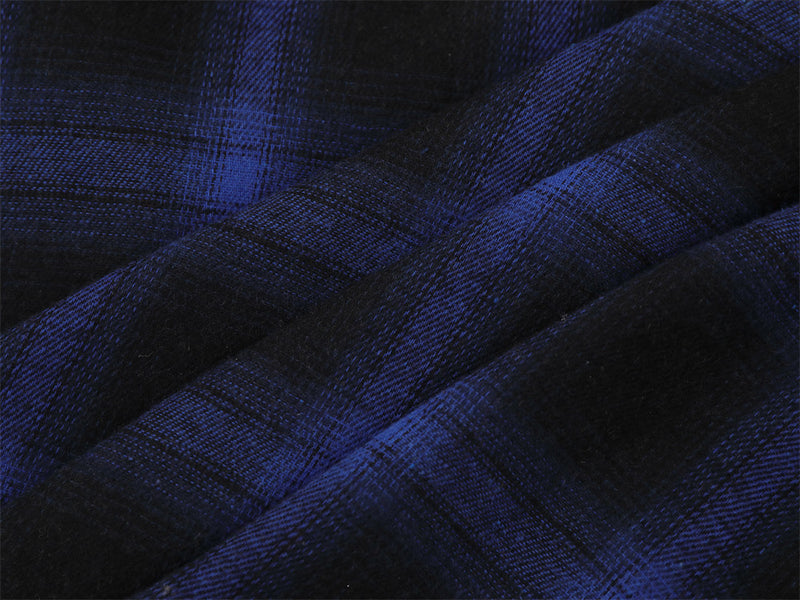 Close-up of blue and black plaid fabric folds and texture