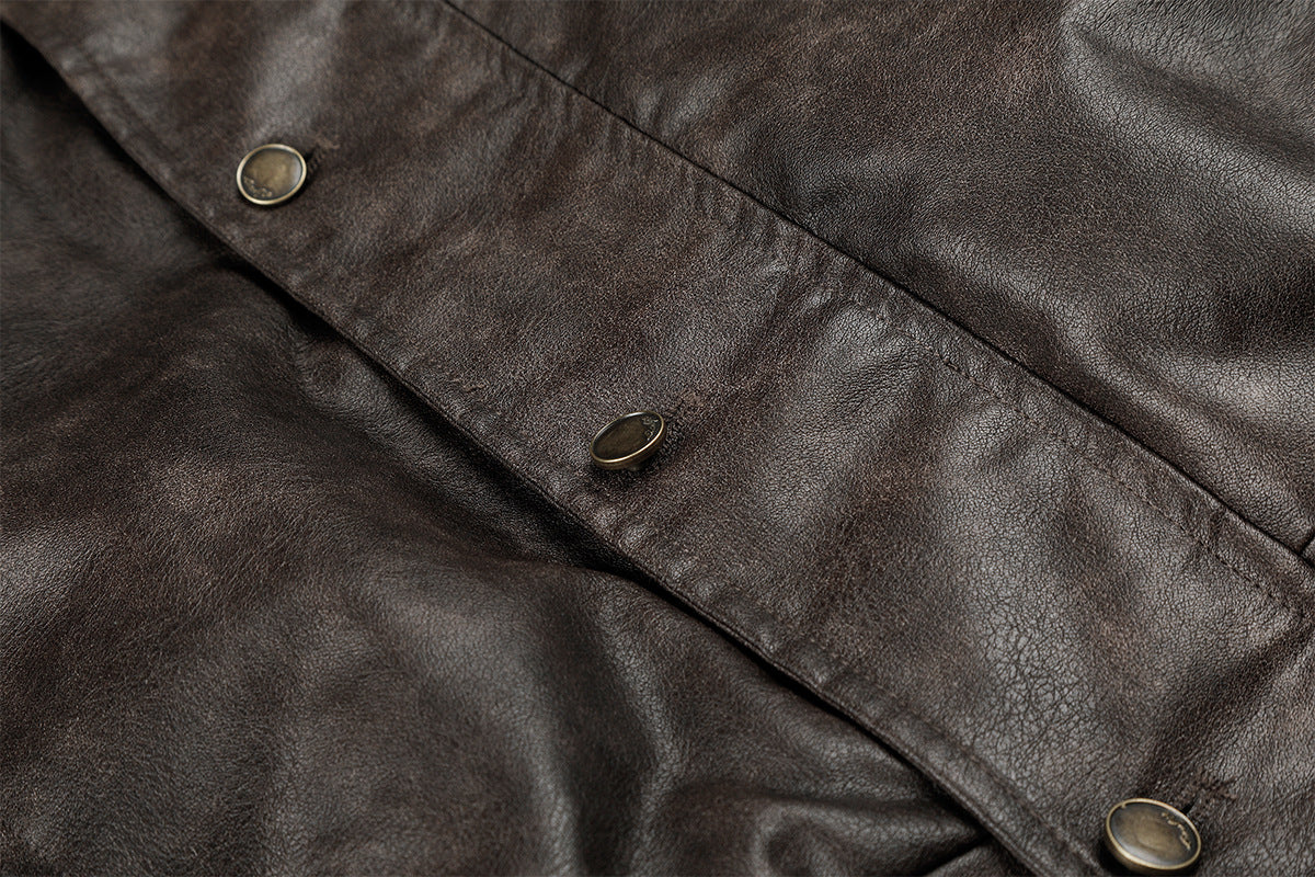 Close-up of the brown faux leather front placket with multiple round snap buttons