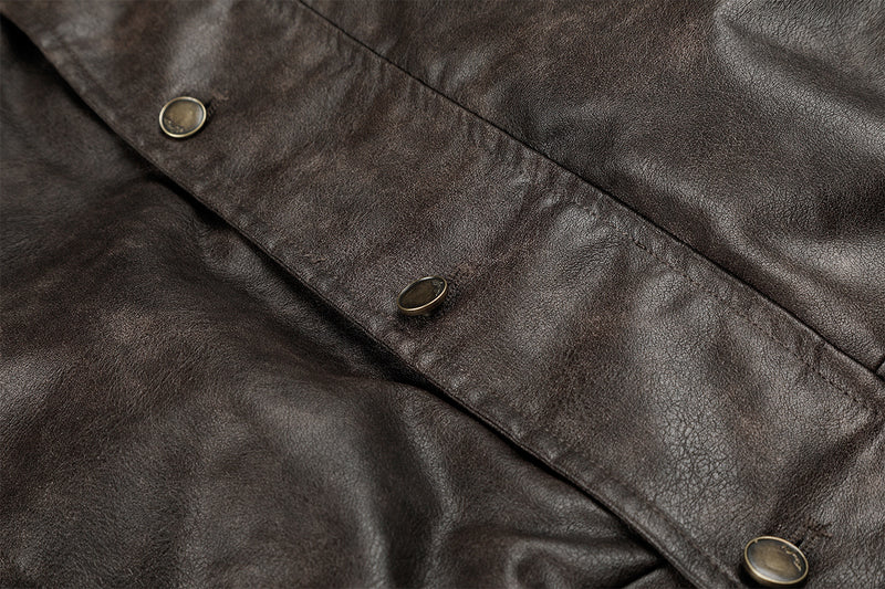 Close-up of the brown faux leather front placket with multiple round snap buttons