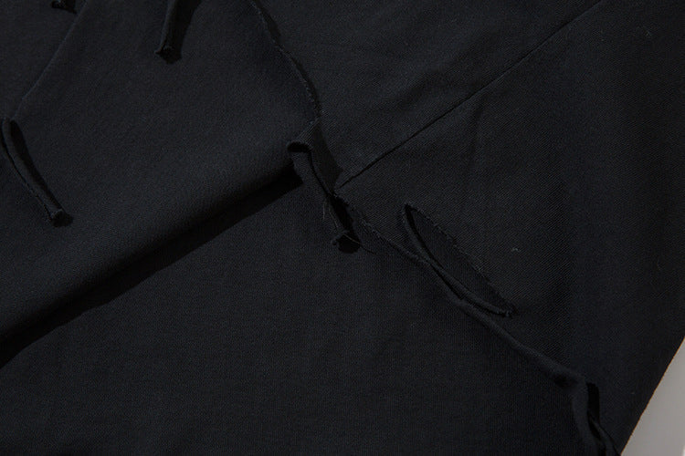 Close-up of the Limited Edition Death Note Long Sleeve Shirt, featuring a black and gray gradient with distressed design and artistic hem, embodying an edgy anime streetwear vibe. Perfect for any fan of Death Note's raw aesthetic.