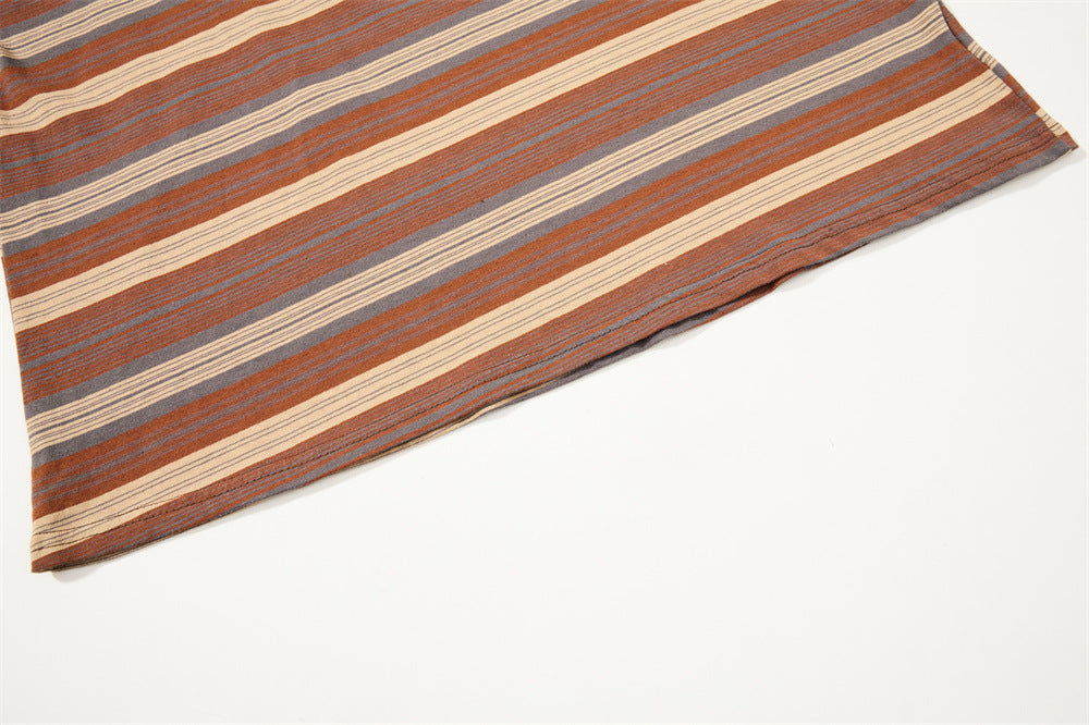 Diagonal close-up of striped shirt hem with brown, gray and cream bands
