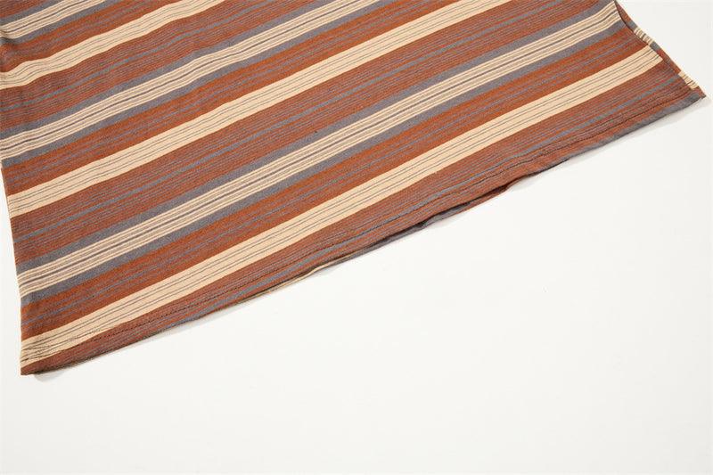 Diagonal close-up of striped shirt hem with brown, gray and cream bands