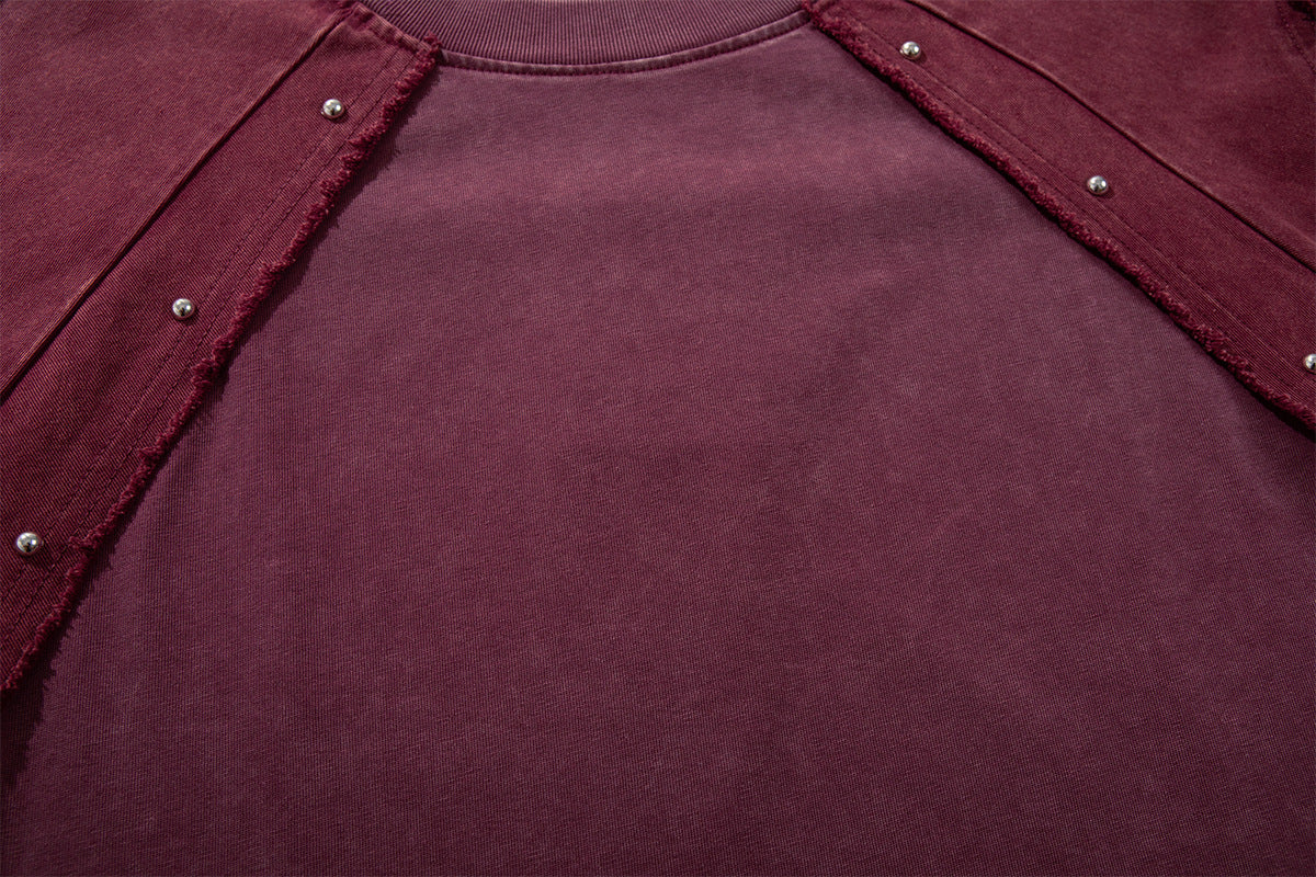 T-shirt patchwork raglan délavé à l’acide, coutures à bords bruts et détails rivetés
