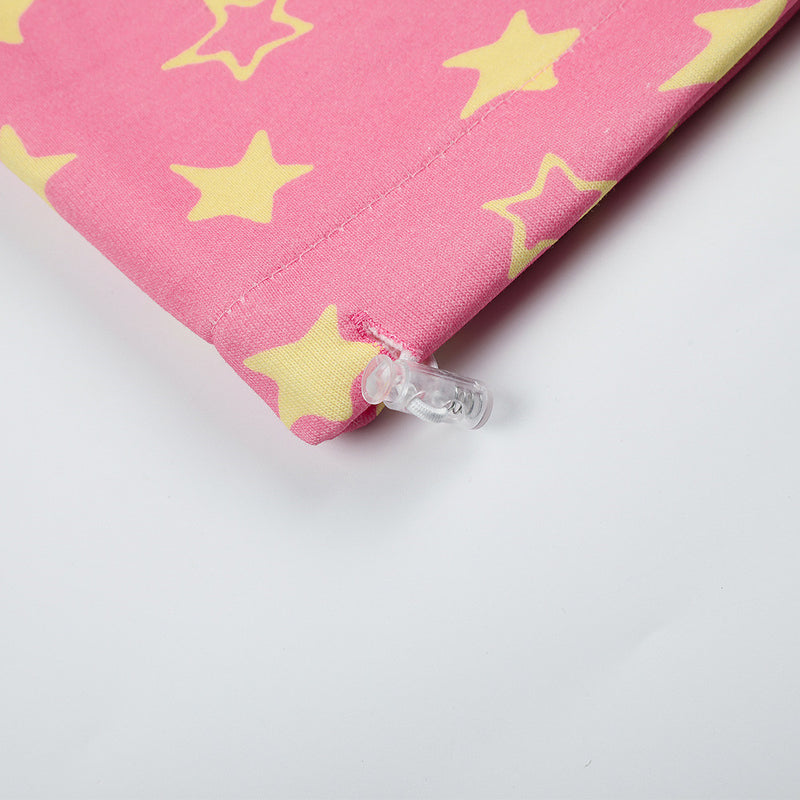 Close-up of pink star print sweatpants hem and adjustable toggle