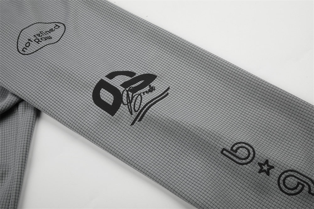 Close-up of gray sleeve with 02 graphic and not refined rain text