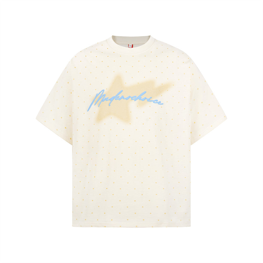 Oversized cream polka dot t-shirt with blurred star and blue cursive script graphic on chest, streetwear style