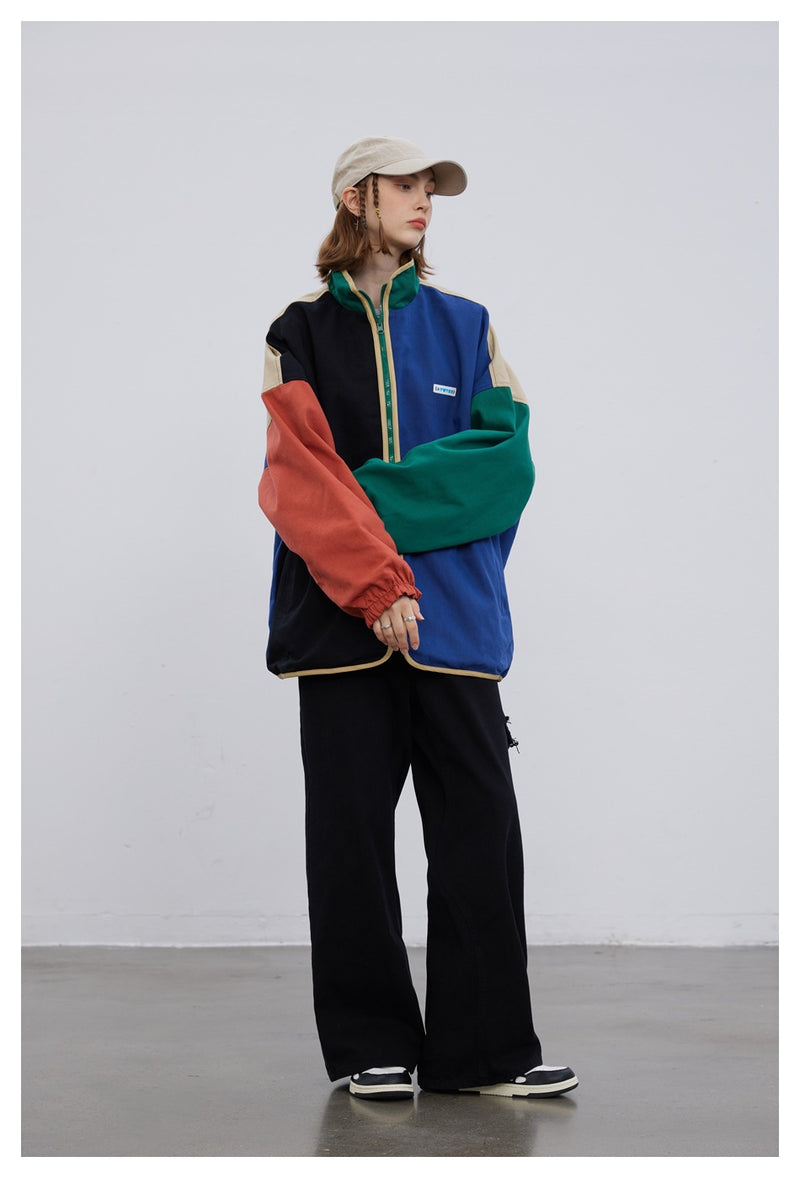 AYWTER colorblock reversible zip-up jacket with stand collar in black, blue, orange, and green panels, oversized fit