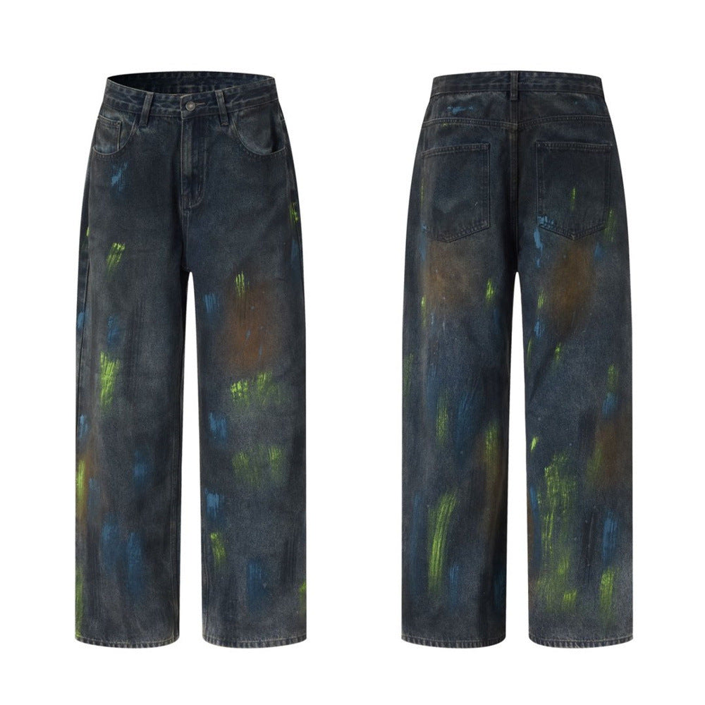 Men's baggy wide-leg dark wash jeans with green and blue paint splatter brushstroke print, front and back view