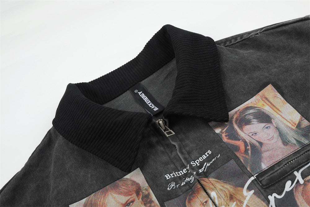 Close-up of black jacket collar and upper chest graphic with zipper and printed portraits