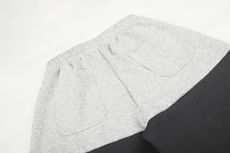 Gerade geschnittene Sweatpants – Colorblock-Baggy-Jogger mit Nieten-Grafik