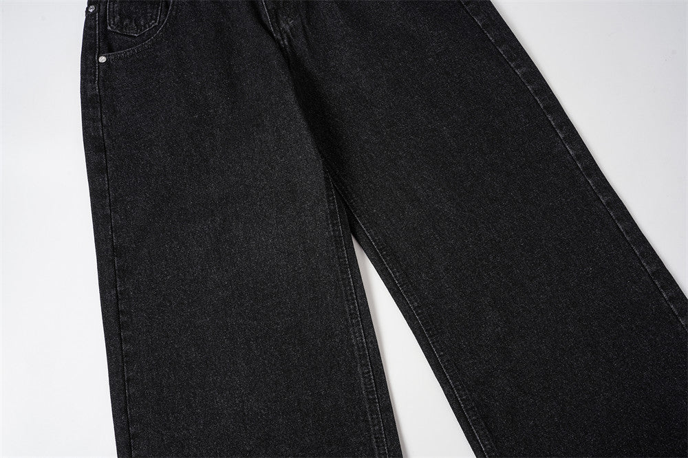 Front leg view of black baggy jeans with wide straight denim legs