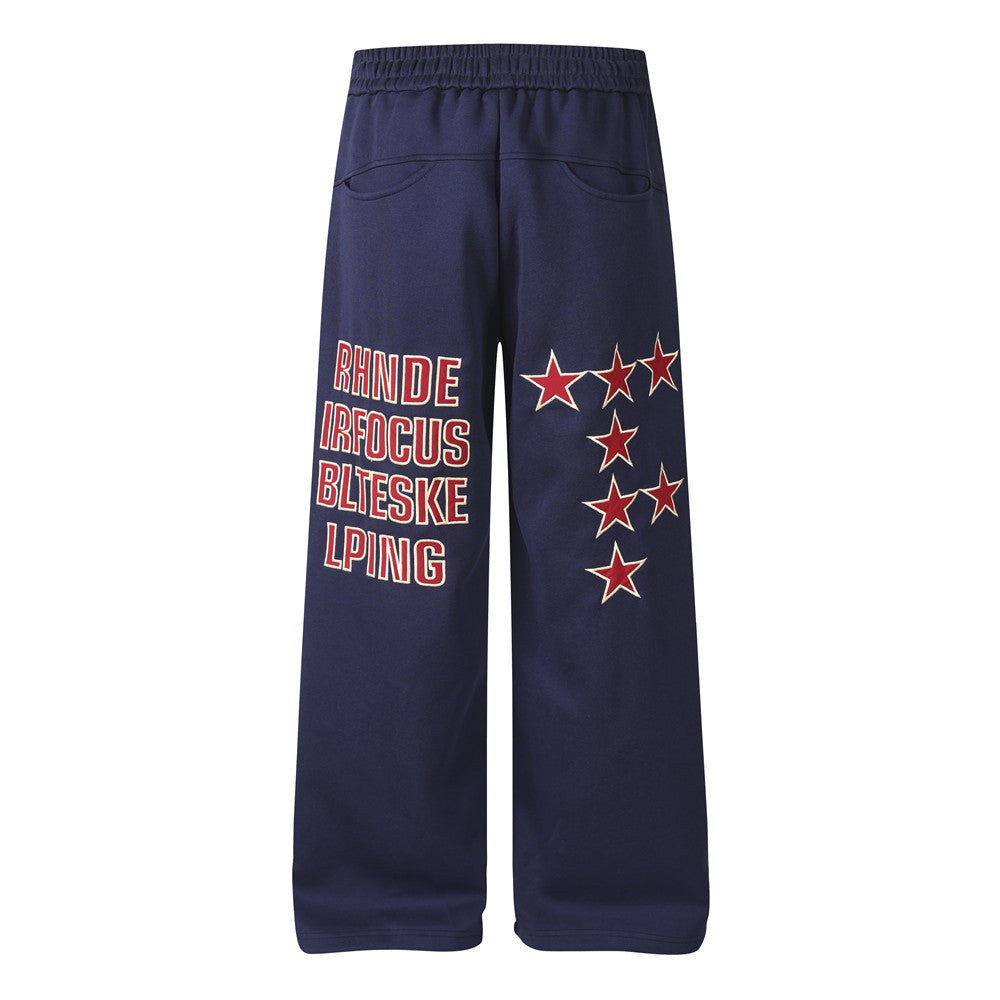 Pantalon de survêtement homme coupe wide leg – Étoiles, lettrage et cordon plissé