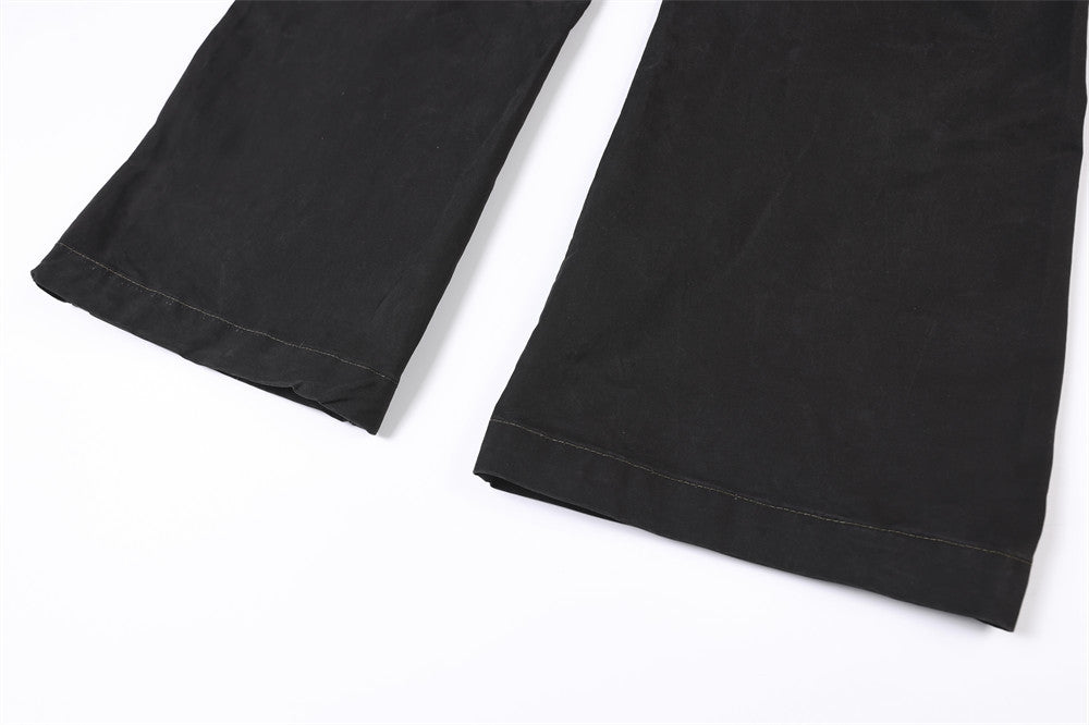 Close-up of wide straight pant legs with black hem stitching