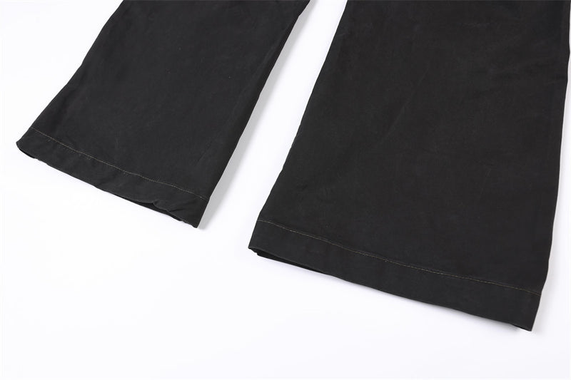 Close-up of wide straight pant legs with black hem stitching