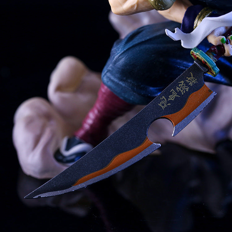 A close-up of the Uzui Tengen Action Figure from Demon Slayer shows a black sword with gold inscriptions and an orange stripe. The figure wears blue pants and maroon socks, capturing the Sound Pillar&