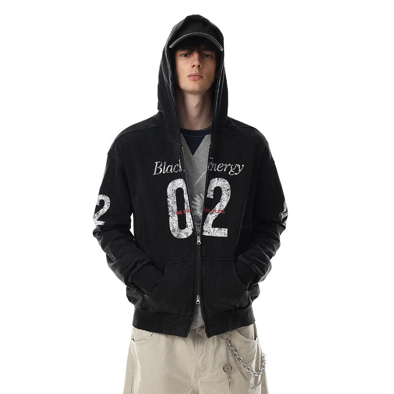 Model wearing black distressed hoodie with hood up and hands in pockets, front view