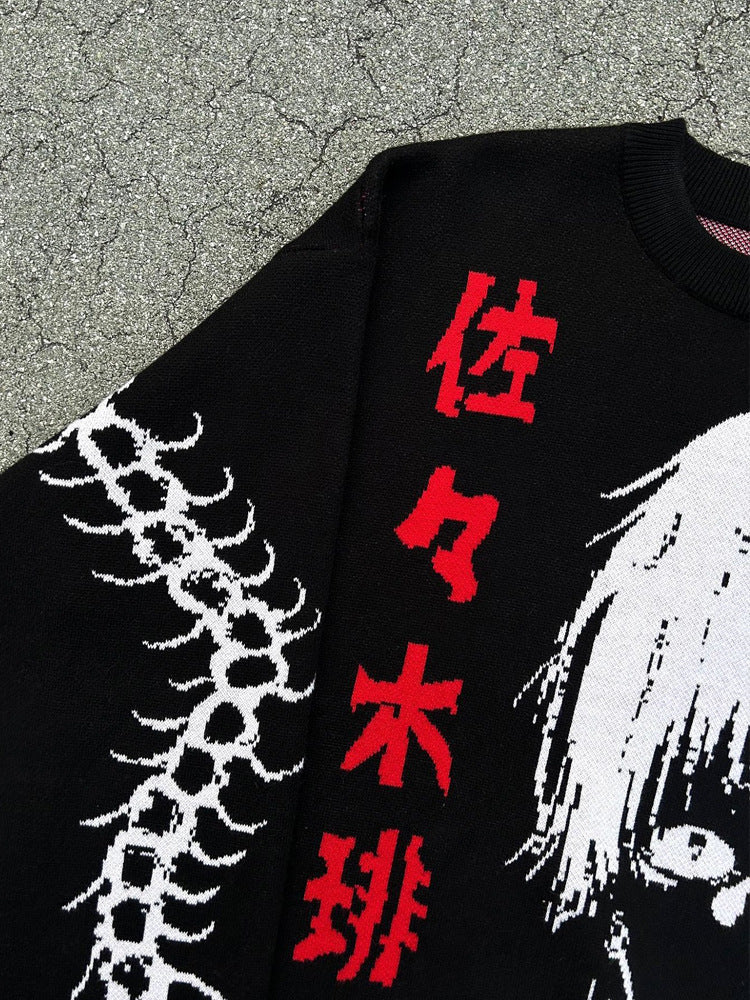 Close-up of a Tokyo Ghoul black sweater with red vertical Japanese characters, a white stylized portrait of Kaneki Ken, and a spine-like sleeve pattern.