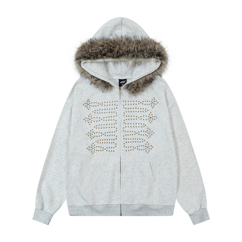 Oversized zip-up hoodie with faux-fur hood trim and gold-tone studded skeleton ribcage graphic on chest, shown in heather gre