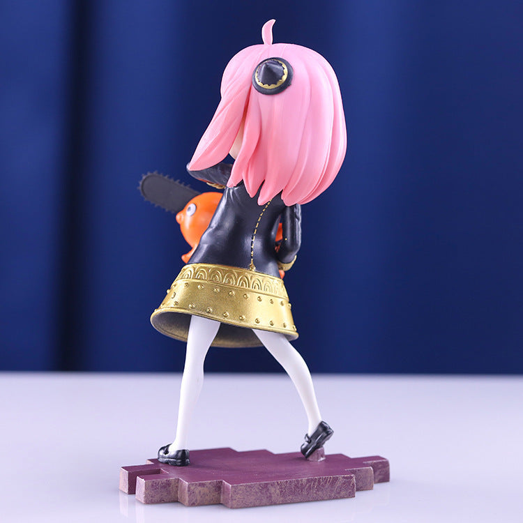 The Anya Forger Chainsaw Cosplay Figure from Spy × Family displays a pink-haired character in a black jacket and yellow skirt, holding a toy chainsaw. Positioned on a decorative blue base, the figure turns away from the viewer, adding mystery and allure—ideal for collectors.