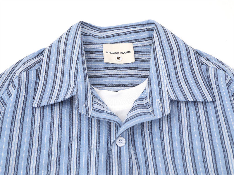 Blue striped shirt upper front close-up showing camp collar and button placket