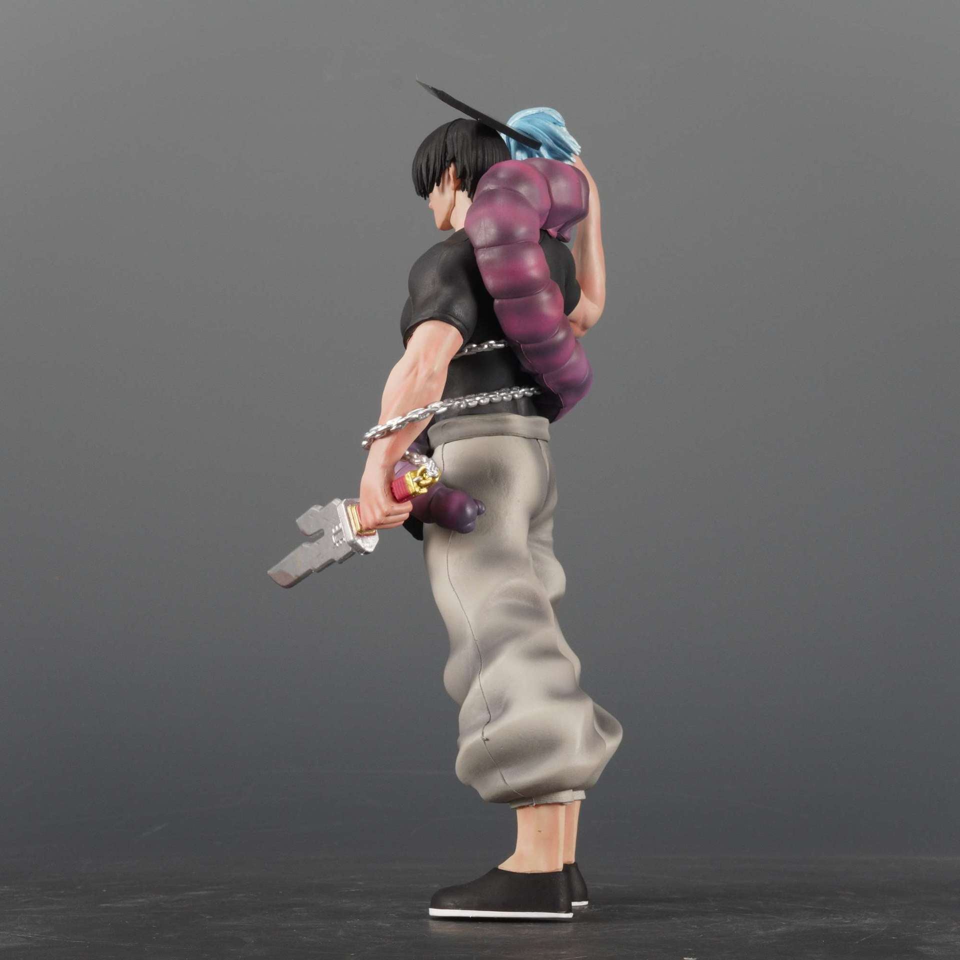 This Jujutsu Kaisen PVC figure, depicting Fushiguro Toji in a dynamic action pose with a sword and shikigami, showcases spiky black hair, a purple snake around the neck, and attire of a black shirt and gray pants against a plain gray background.