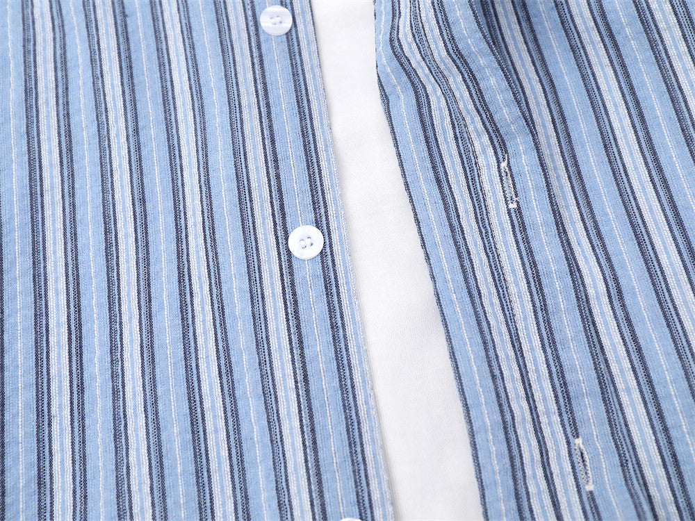 Blue striped shirt front placket close-up with faux layered opening