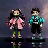 Two PVC figures from the Demon Slayer 4-Piece Set, each standing 17cm, are posed on black bases. Nezuko wears a pink and dark green outfit with long hair, while Tanjiro sports a green and black ensemble with short hair—the perfect anime gift.