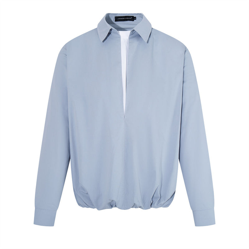 Oversized v-neck long sleeve pullover shirt with faux-layered collar and elasticated balloon hem in white and steel blue