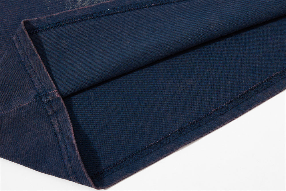 Close-up of navy raglan T-shirt sleeve with visible stitching and colorblock seam detailing
