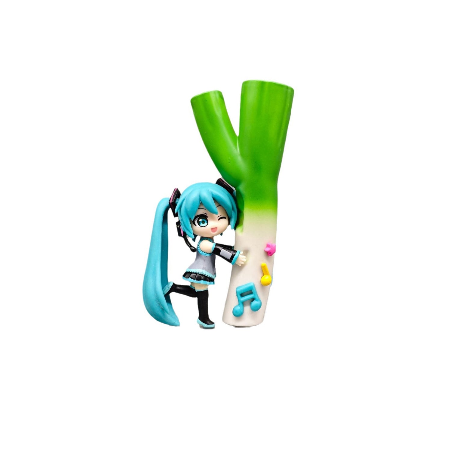 The Chibi Hatsune Miku Holding Green Onion 12cm PVC Figure features the character in a cute, playful Q-version, with long teal hair and a black and teal outfit, headphones on, posed beside a giant green onion while holding a microphone as musical notes dance around the vibrant leek.