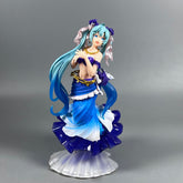 The Hatsune Miku Mermaid 24cm PVC Figure is an elegant collectible featuring a female character with long blue hair, a blue and white ruffled dress with gold accents and bows. Her graceful pose, hands near her chest, is atop a shell-like base.