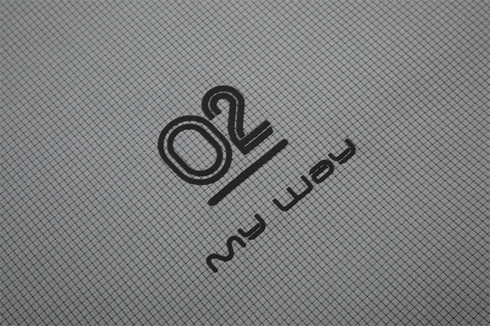 Close-up of gray shirt hem print with O2 logo and my way text