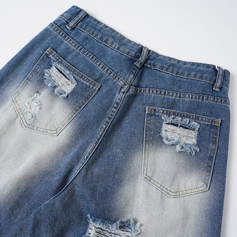 Back pocket detail on faded blue jeans with frayed distressing