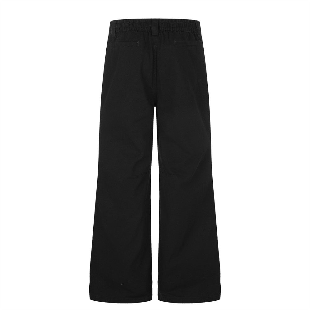 Pantalon homme coupe large orné de perles et de clous métalliques