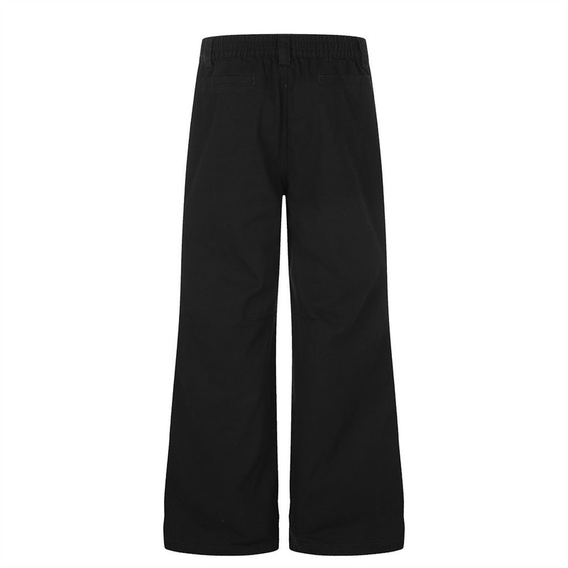 Pantalon homme coupe large orné de perles et de clous métalliques