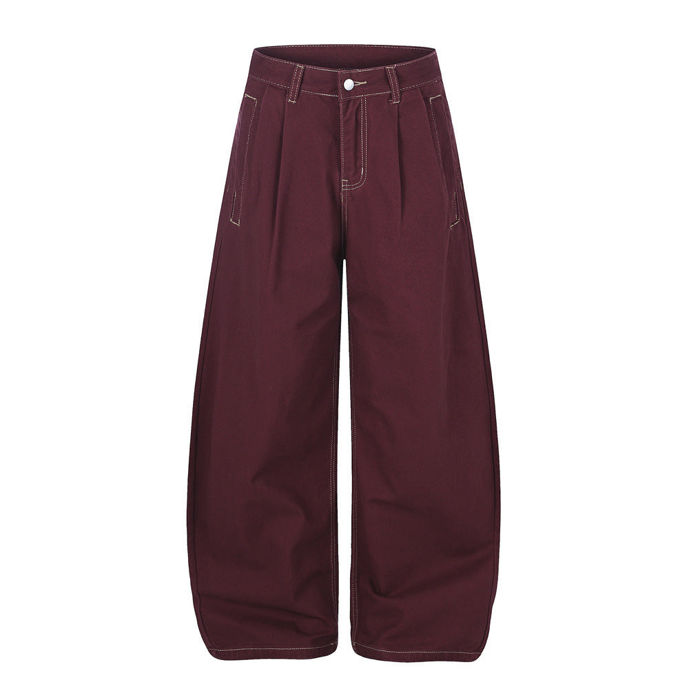 Men's wide-leg pleated trousers with curved barrel leg and contrast stitching in burgundy