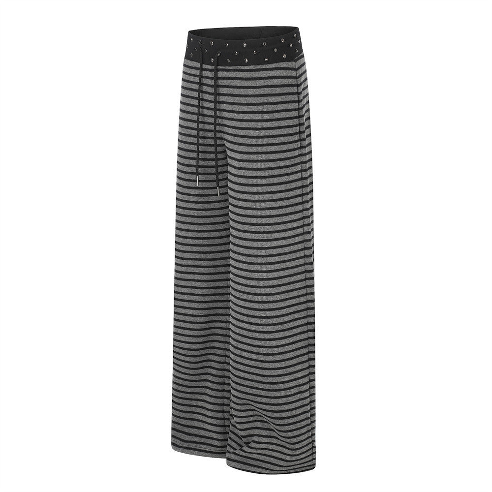 Black and gray striped wide-leg pants with studded waistband and drawstring, angled front view